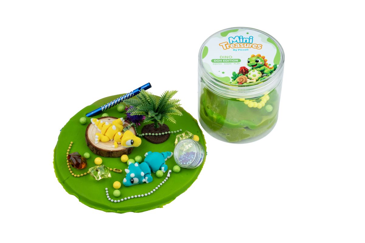 Dino tub opened: green doh with little dinosaurs and a palm