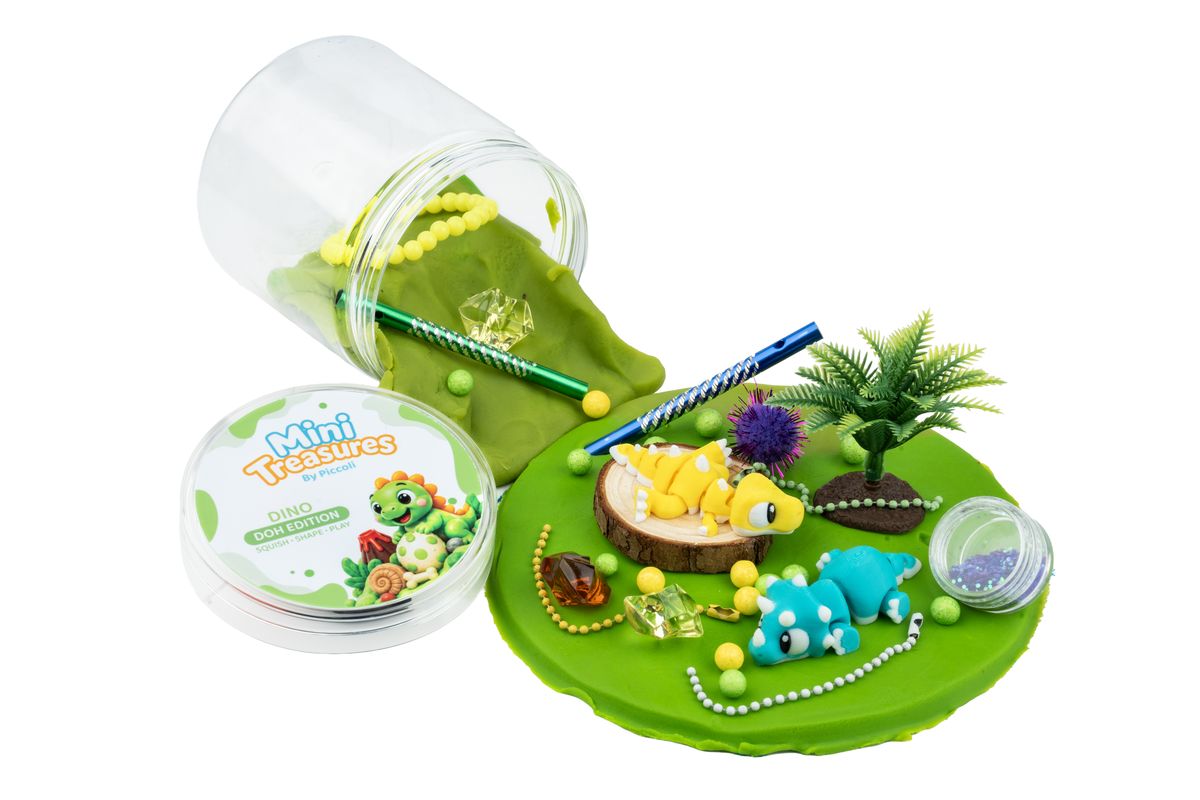 Dino tub with its lid off, green doh spilling out